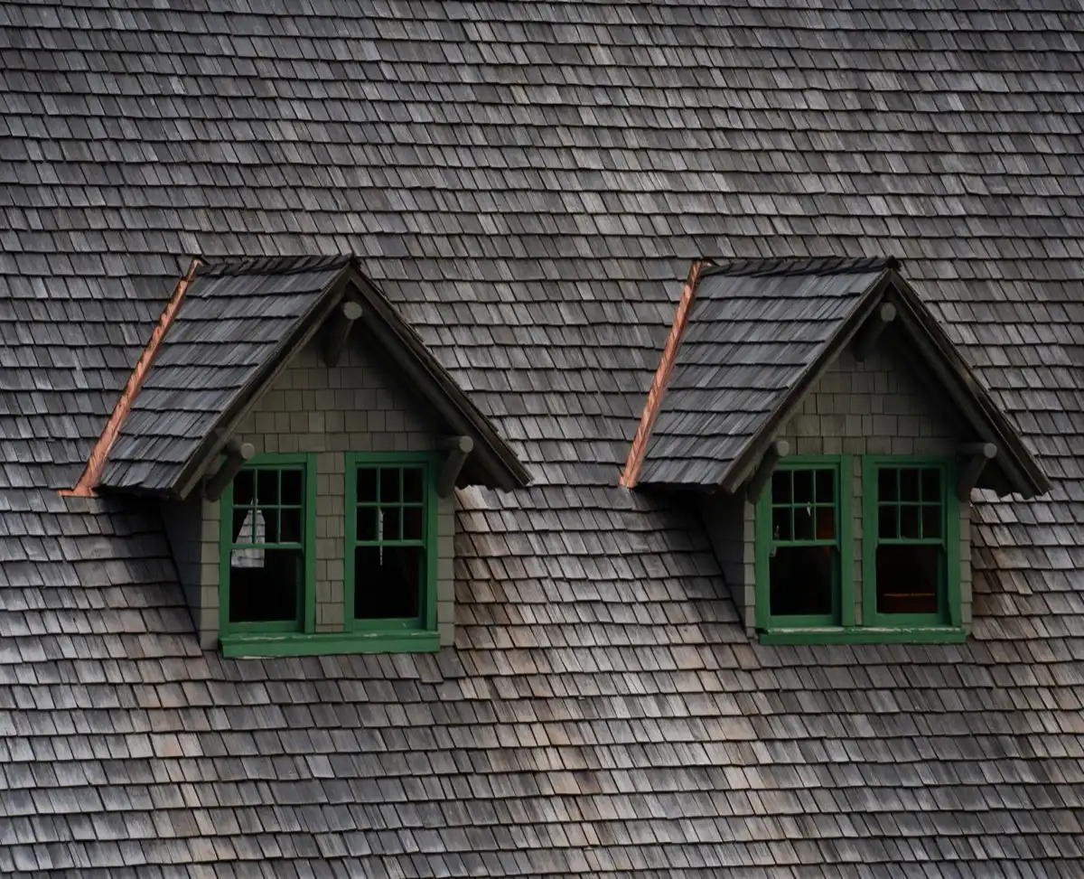 Dormers on a shingle roof in Battle Creek, MI, where step flashing and kickout flashing carry water past the walls